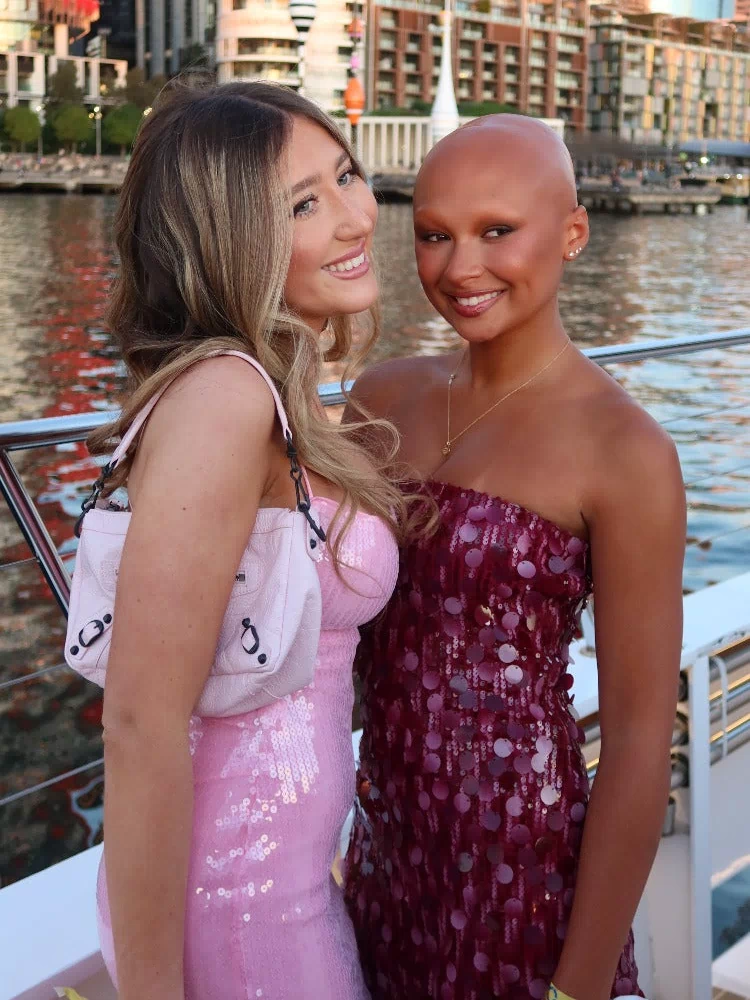 Front view of a fitted pink sequin strapless mini dress with a straight neckline