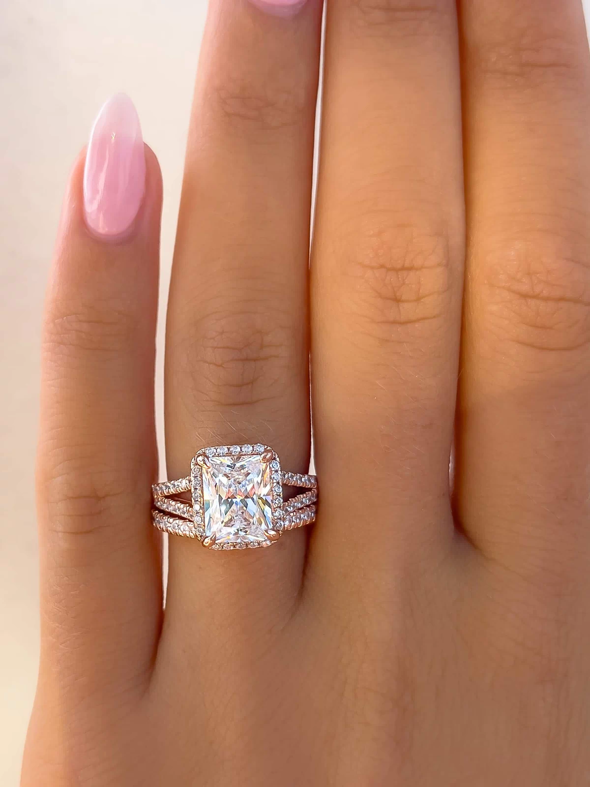 Radiant cut, with a shimmering halo surrounding the center stone with a unique, split half eternity band