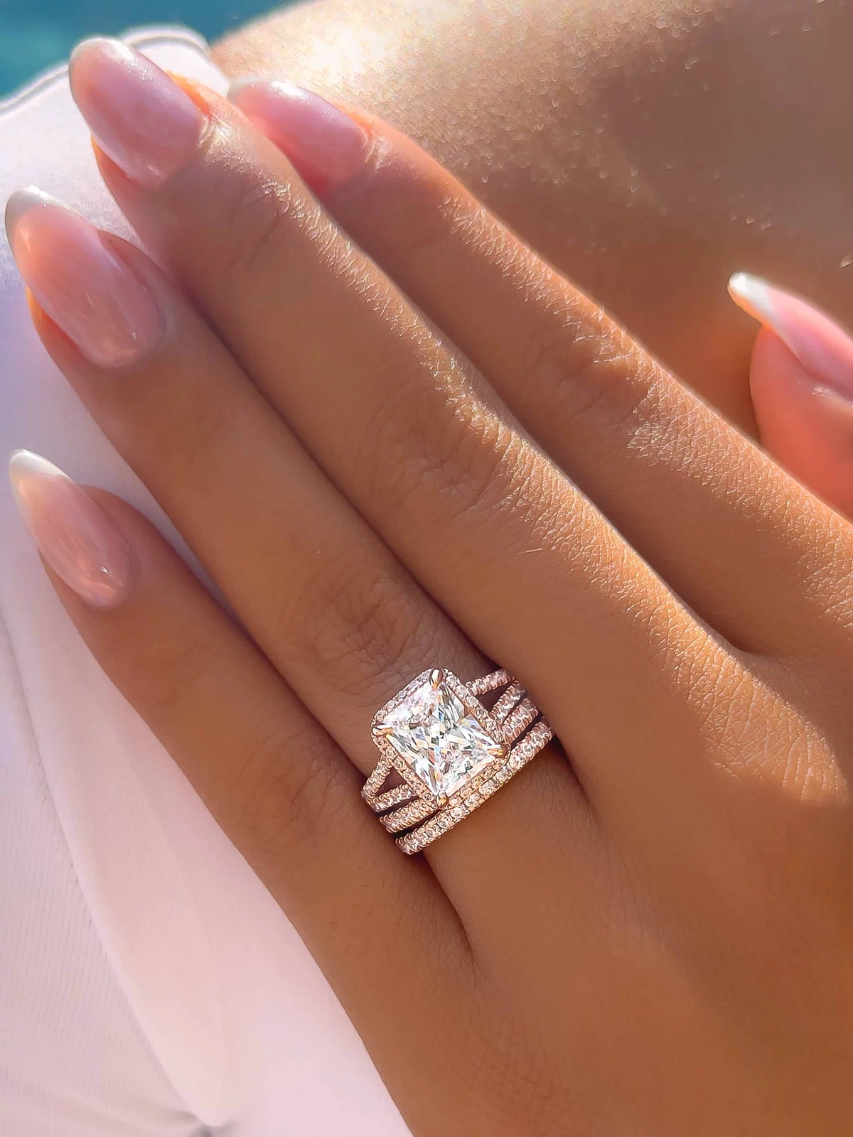 triple stack radiant cut engagement ring on models hand