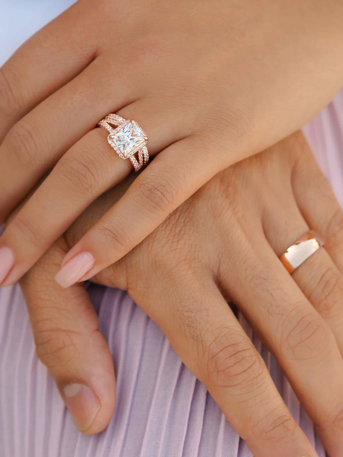 stunning rose gold affordable men's horizon wedding band and rose gold radiant cut wedding ring set shown on couple's hands