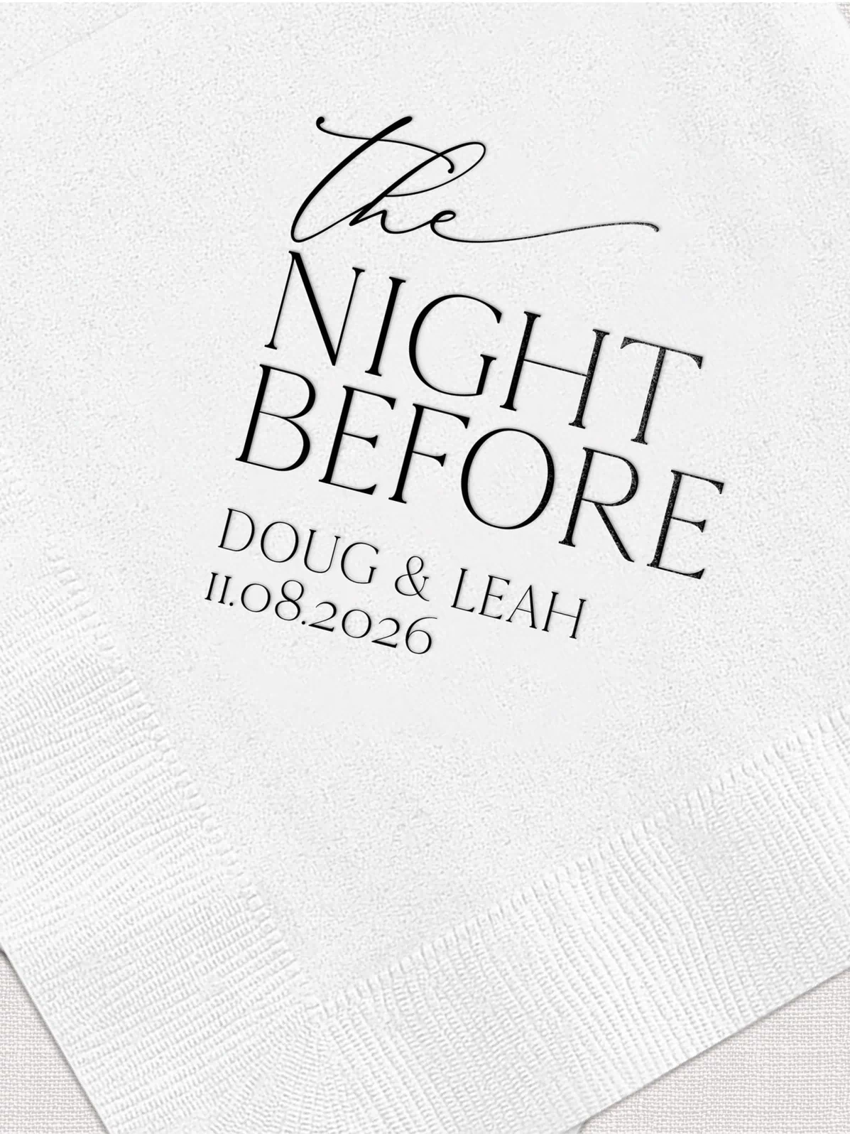 White napkins with "The Night Before" text and personalized names "Doug & Leah" with date 11.08.2026 in foil stamped design