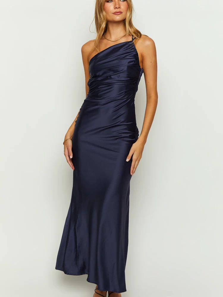 Front view of a navy satin maxi dress featuring a one-shoulder neckline and ruched detailing on the bodice