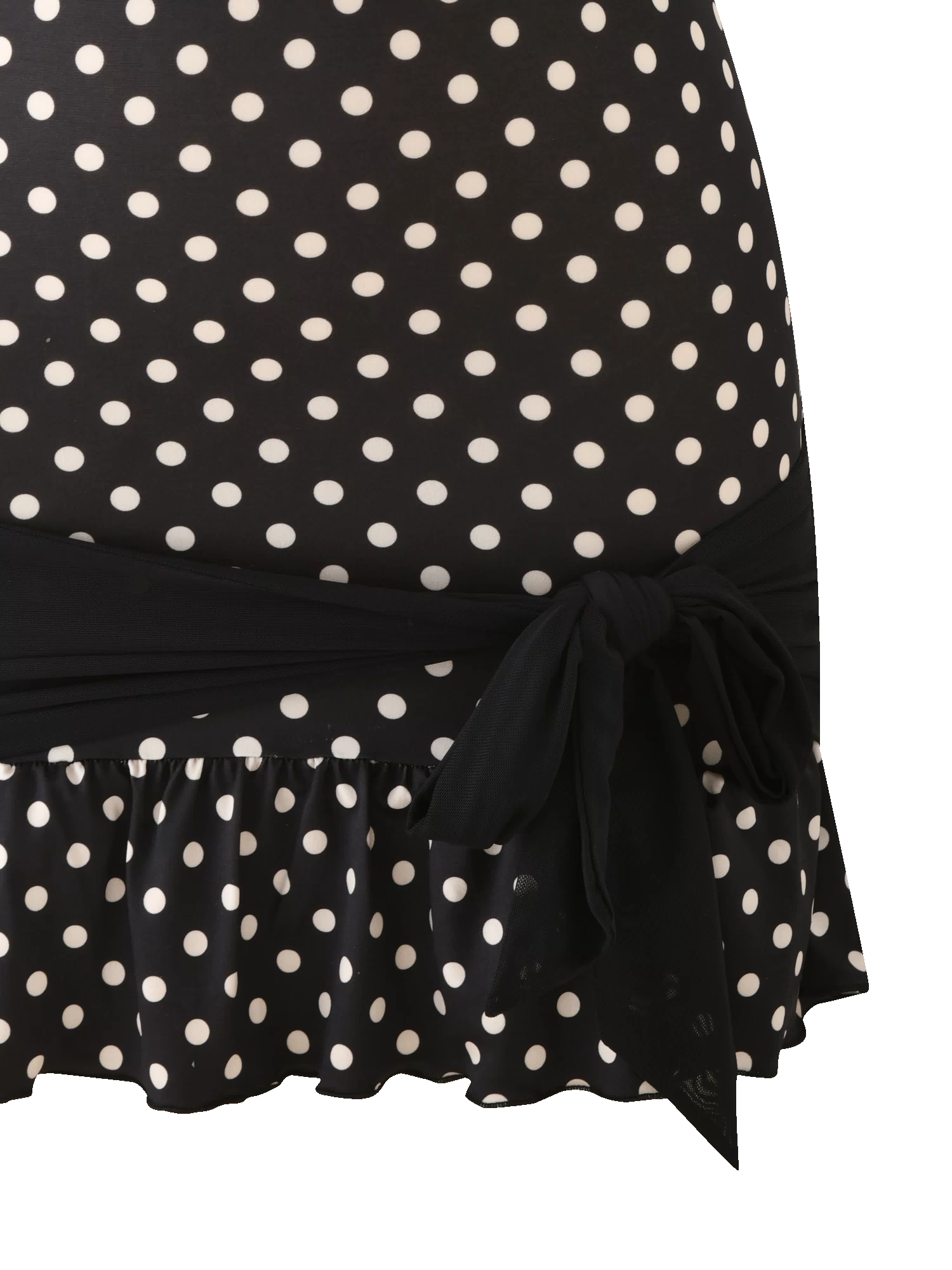 A close-up of the TOVE MINI DRESS - BLACK POLKA DOT by TIGERMIST, featuring white polka dots, a ruffle hem, and a black tie at the waist for a playful touch on the bodycon silhouette.