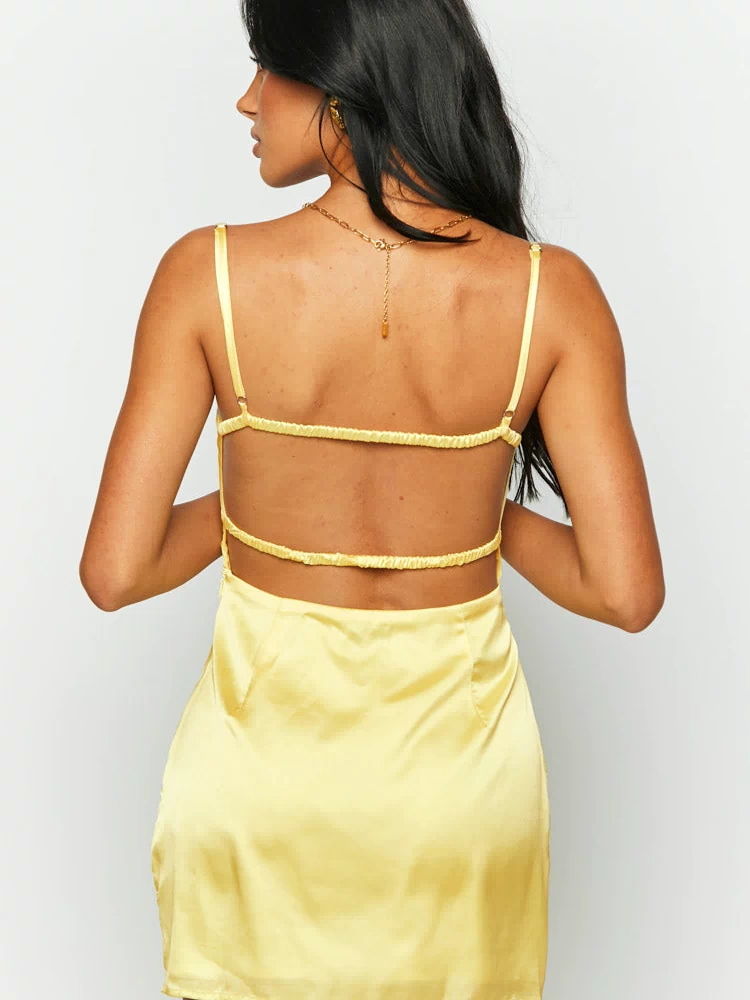 Rear view of a yellow satin mini dress with a low open back and three horizontal elasticated straps
