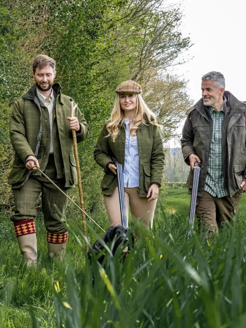 Three people in countryside gear wearing a stylish tweed shooting jacket