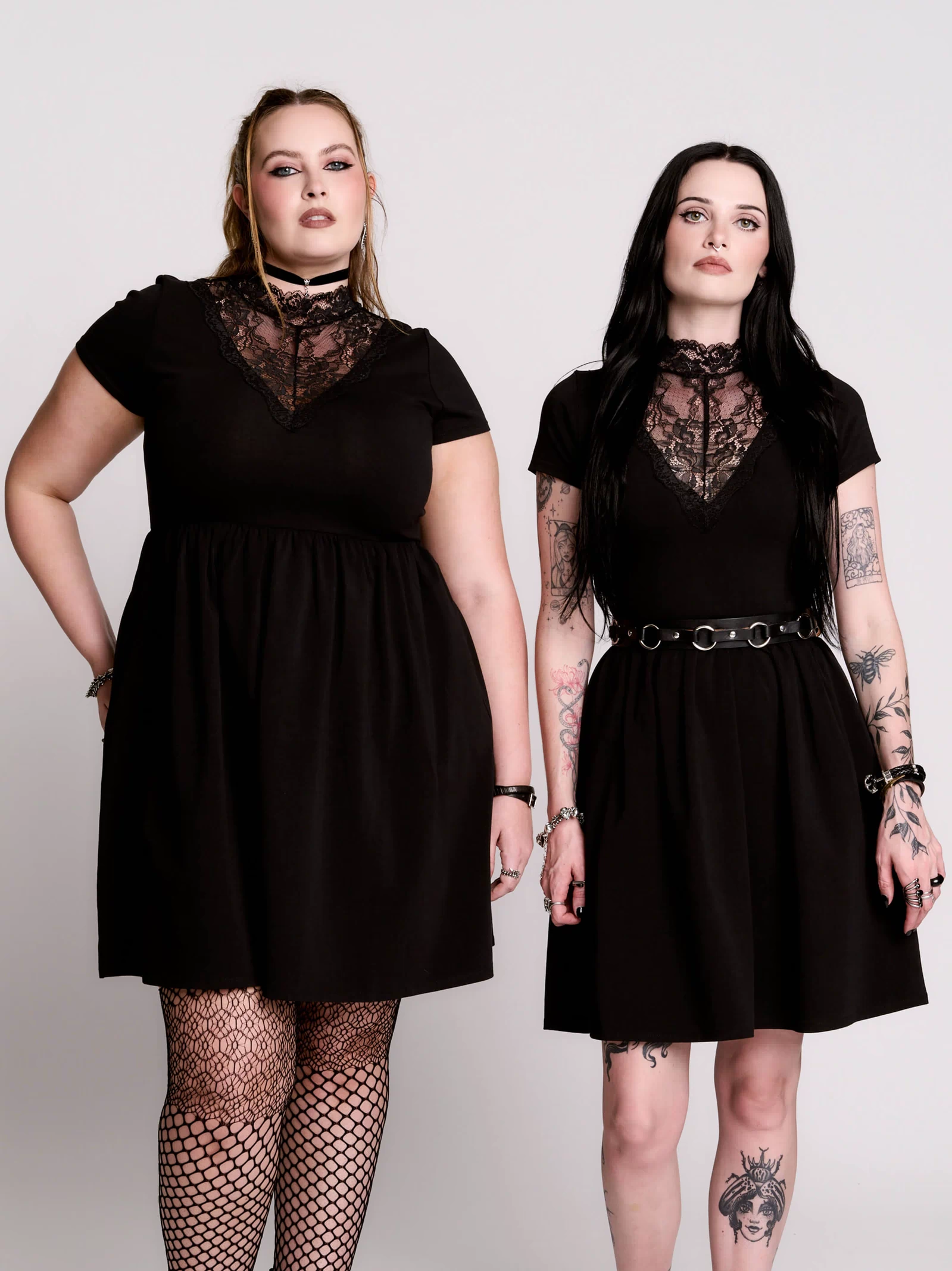 A black short-sleeve dress with a lace V-neckline.