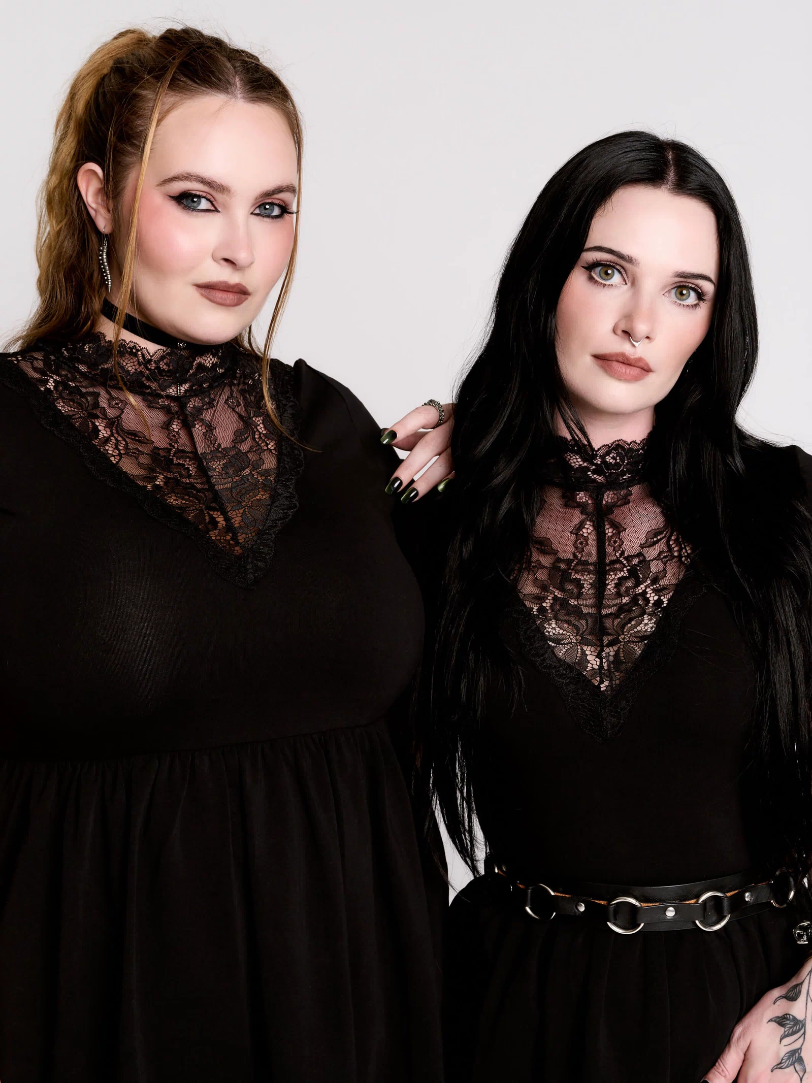 A black short-sleeve dress with a lace V-neckline.