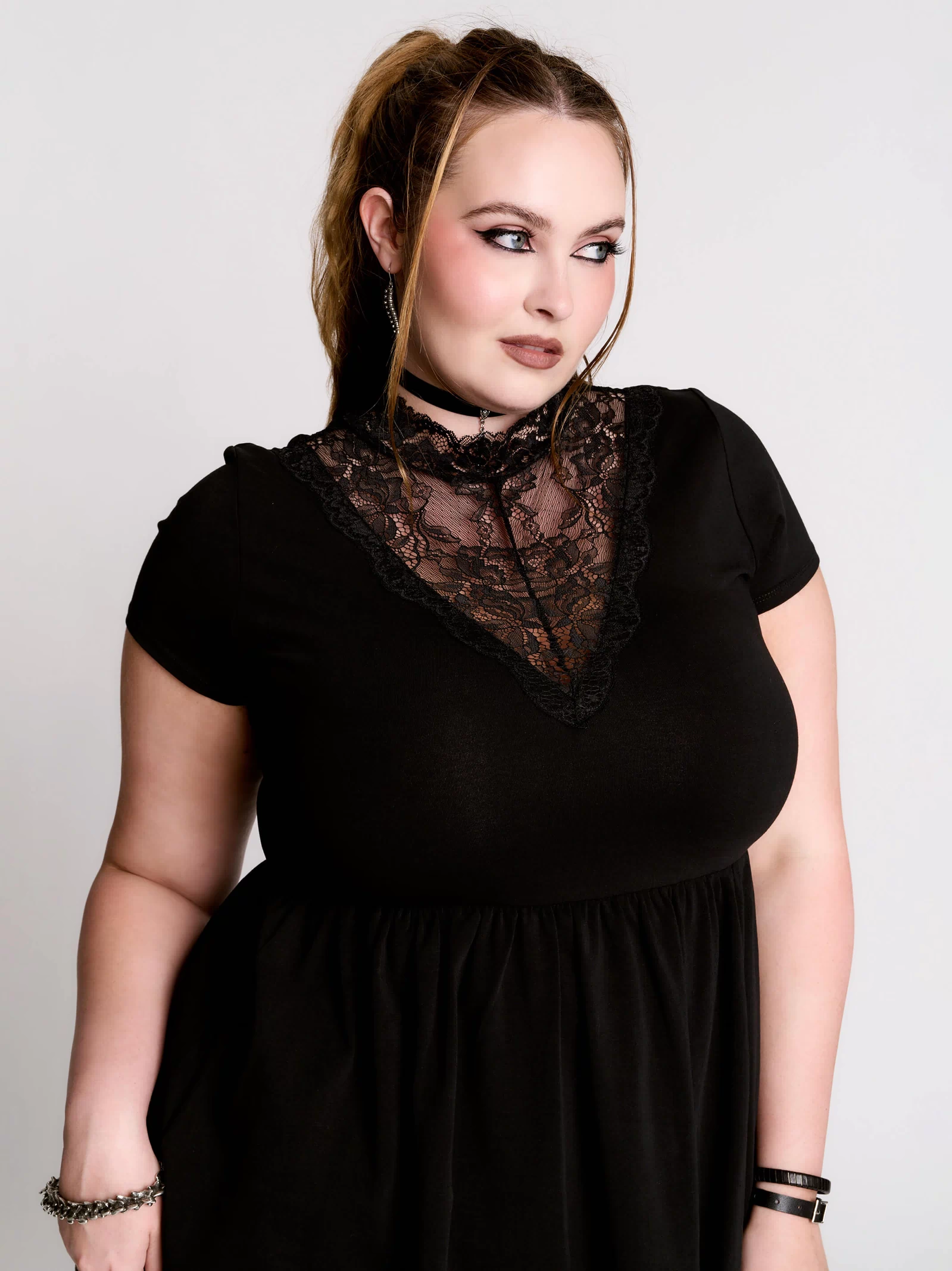 A black short-sleeve dress with a lace V-neckline.