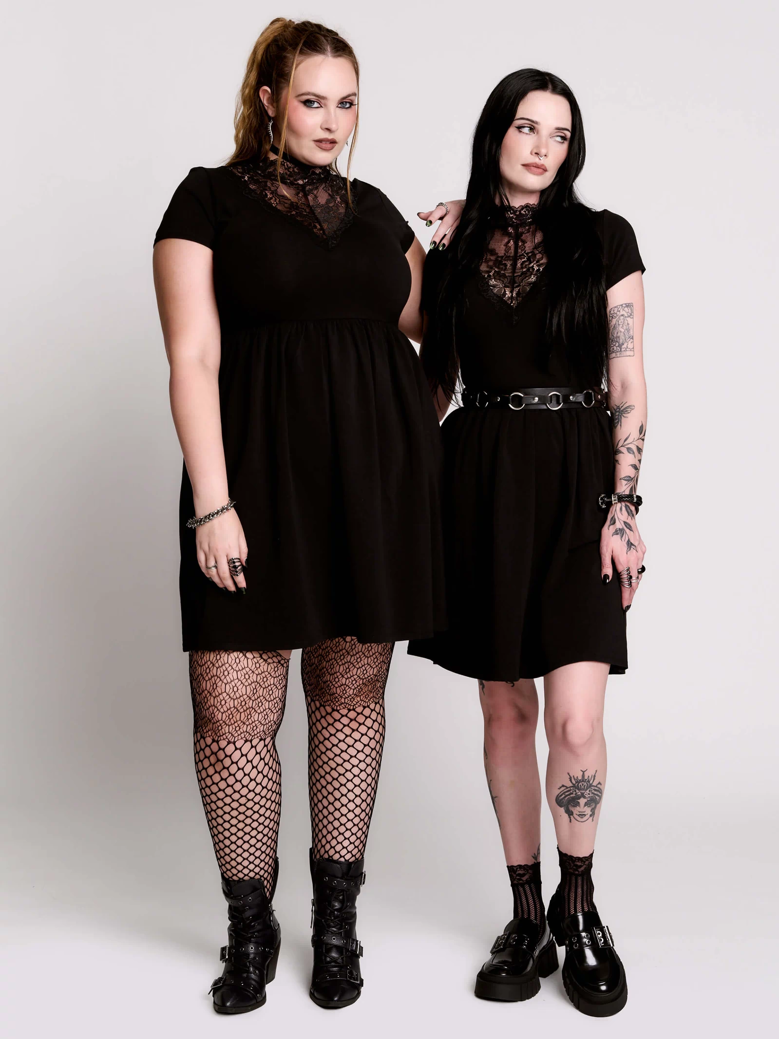 A black short-sleeve dress with a lace V-neckline.