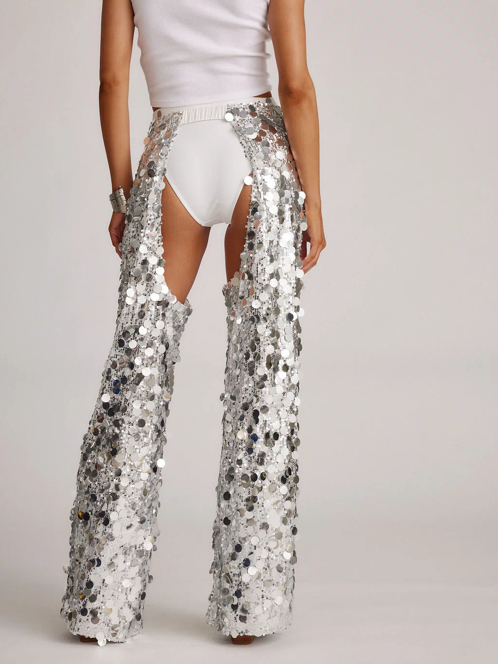Back view of the silver pants showing the silhouette and fit.