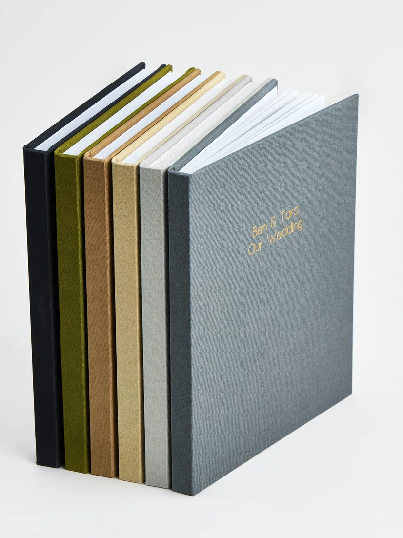 Set of wedding photo albums with linen covers and gold foil text