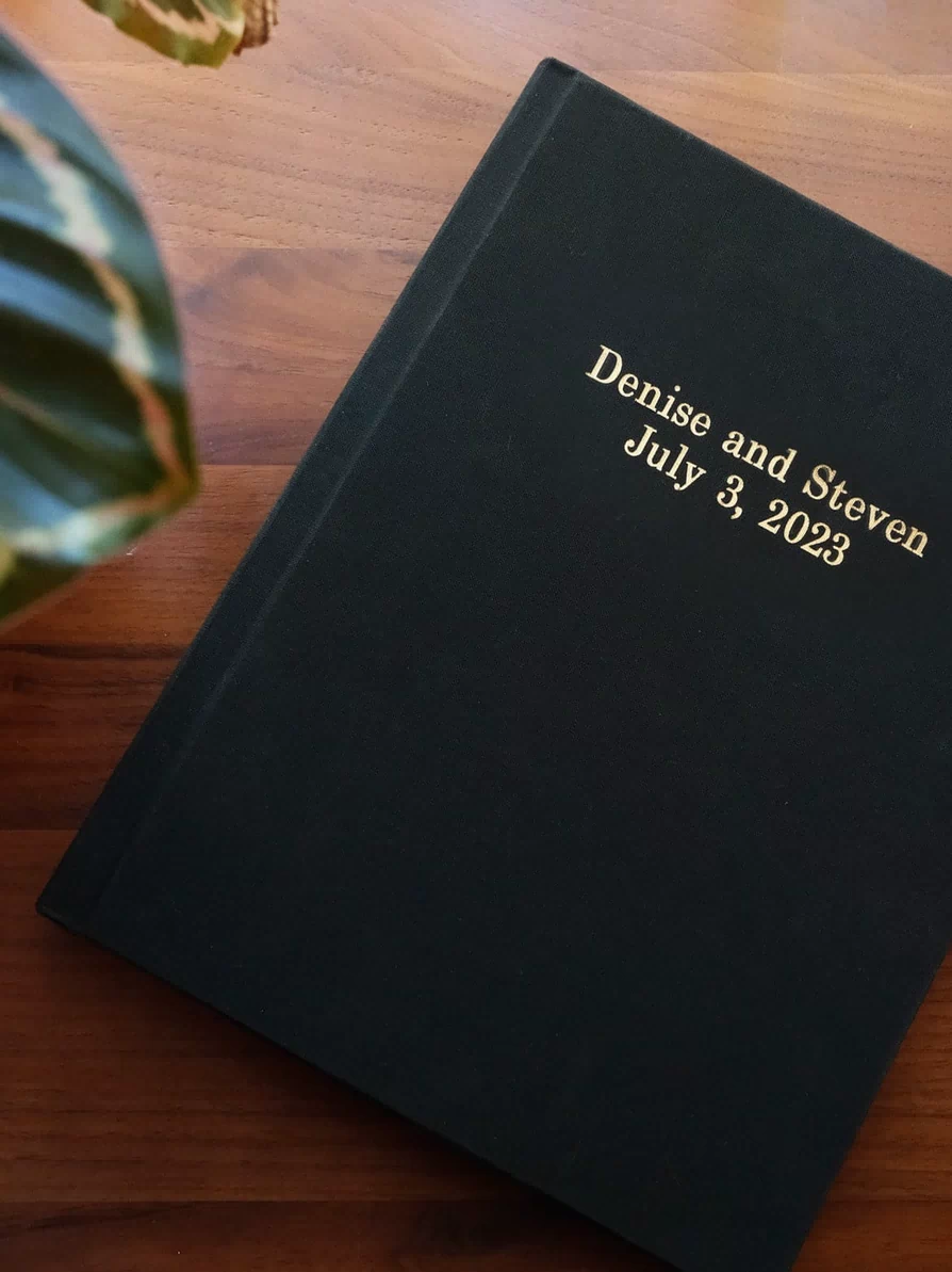 Black linen wedding photo album with gold foil lettering