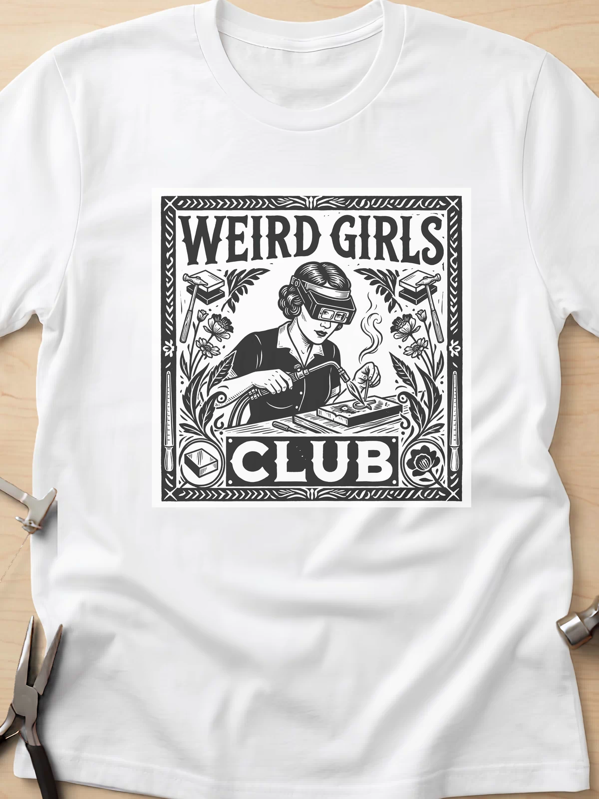 Weird Girls Club funny metalsmith t-shirt in White, flat lay with jeweler's tools