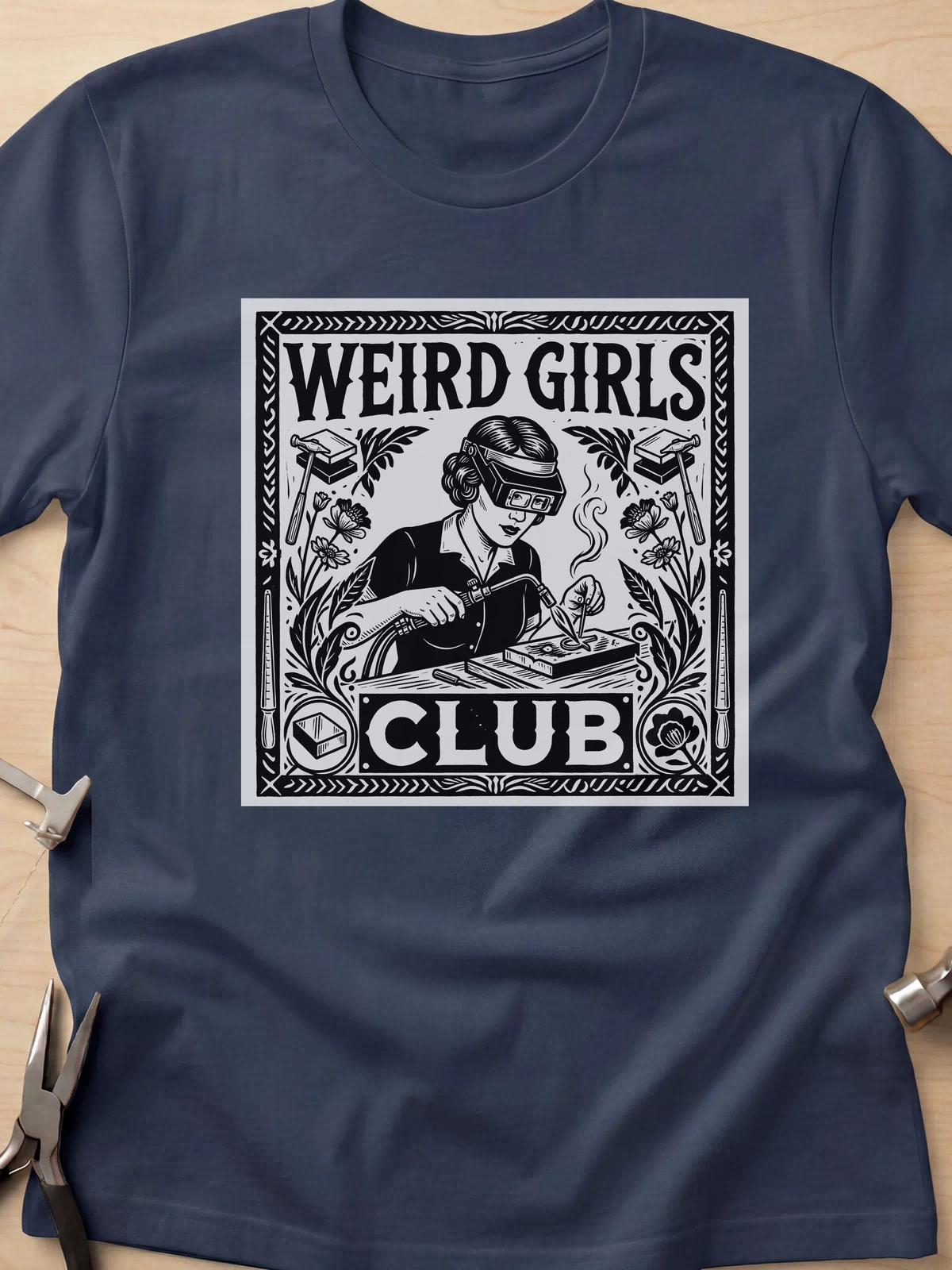 Weird Girls Club funny metalsmith t-shirt in Navy, flat lay with jeweler's tools