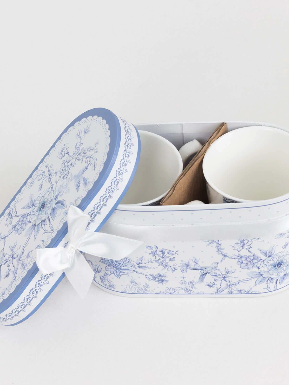 Blue and white floral ceramic mug set in decorative storage box