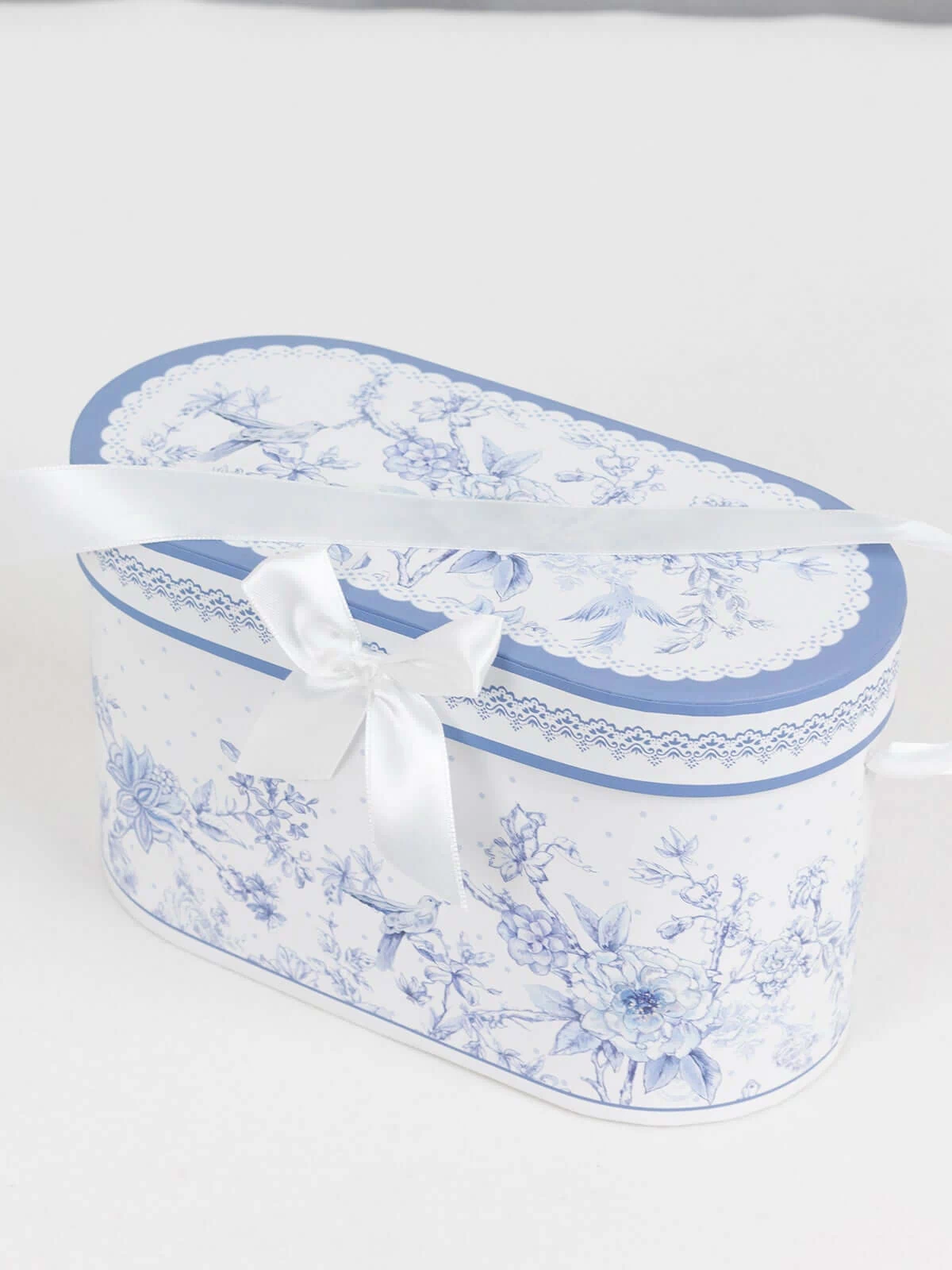 Decorative blue floral gift box with a satin ribbon bow