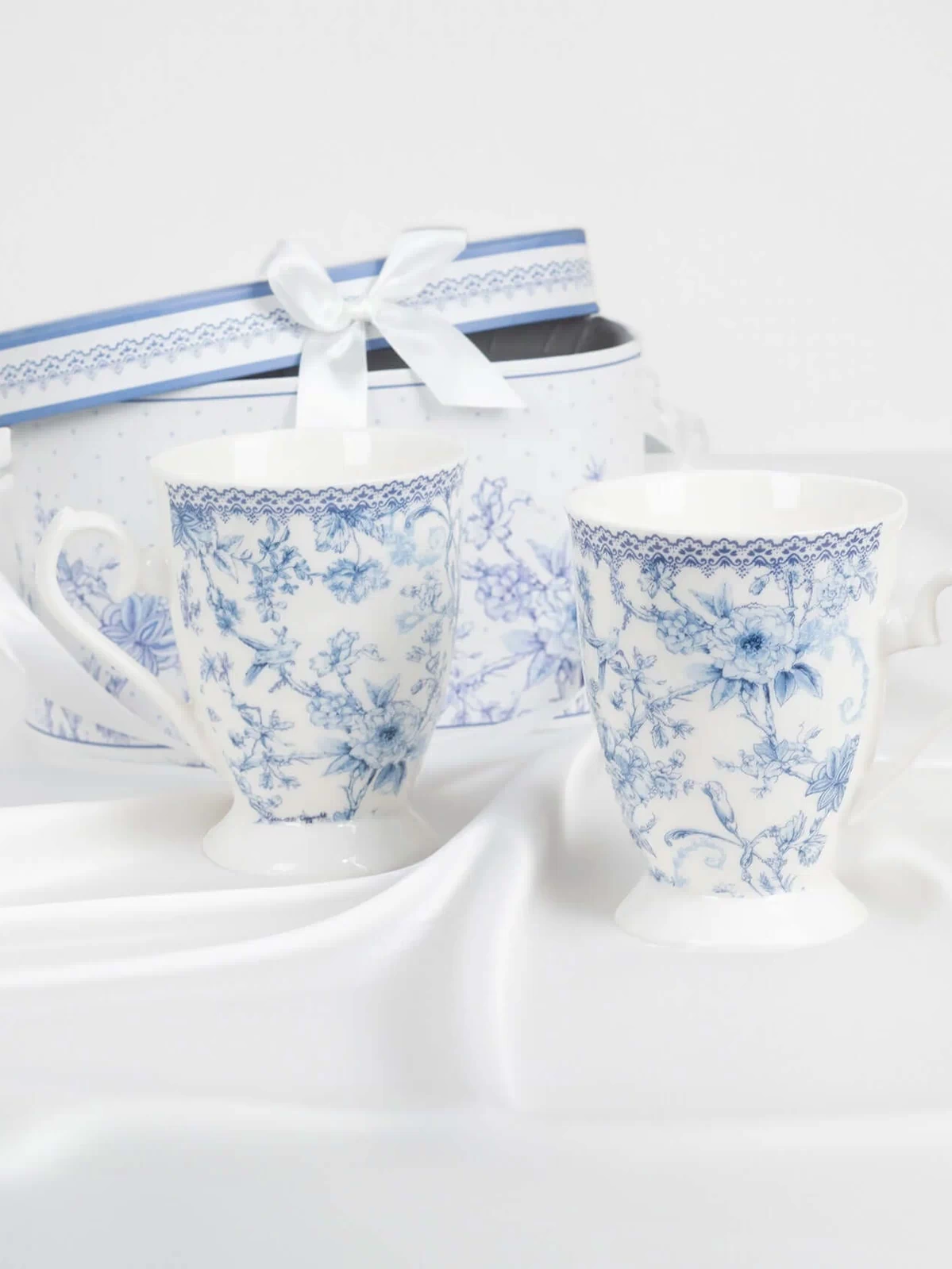 Blue floral tea cups with a matching gift box on a white background.