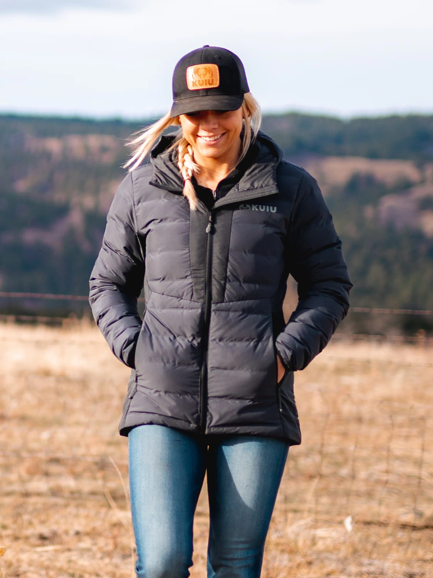 Woman wearing Elements Hooded Jacket in Gunmetal with hands inside zippered hand pockets