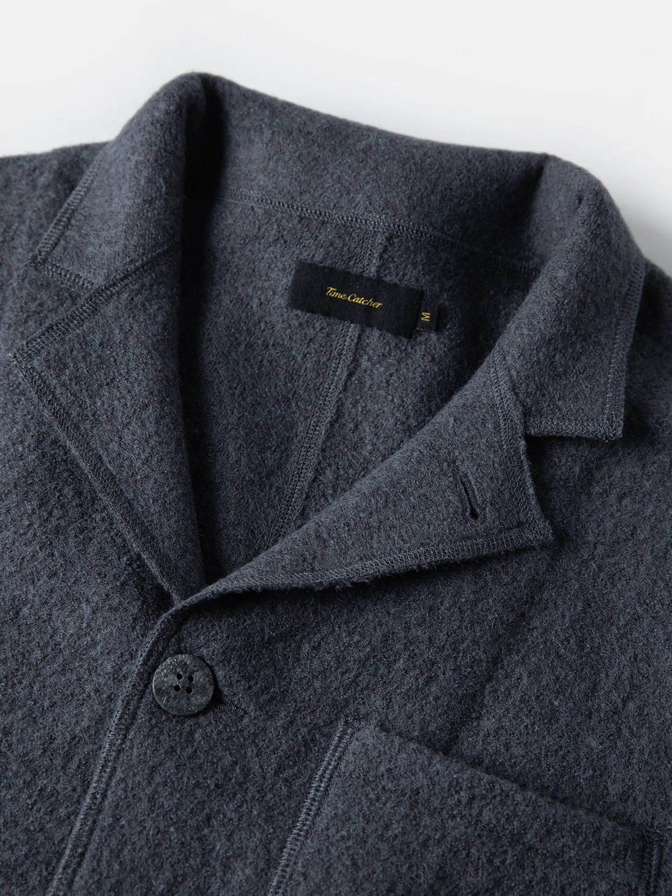 Gray wool felted chore coat lapel and front button placket with inside label