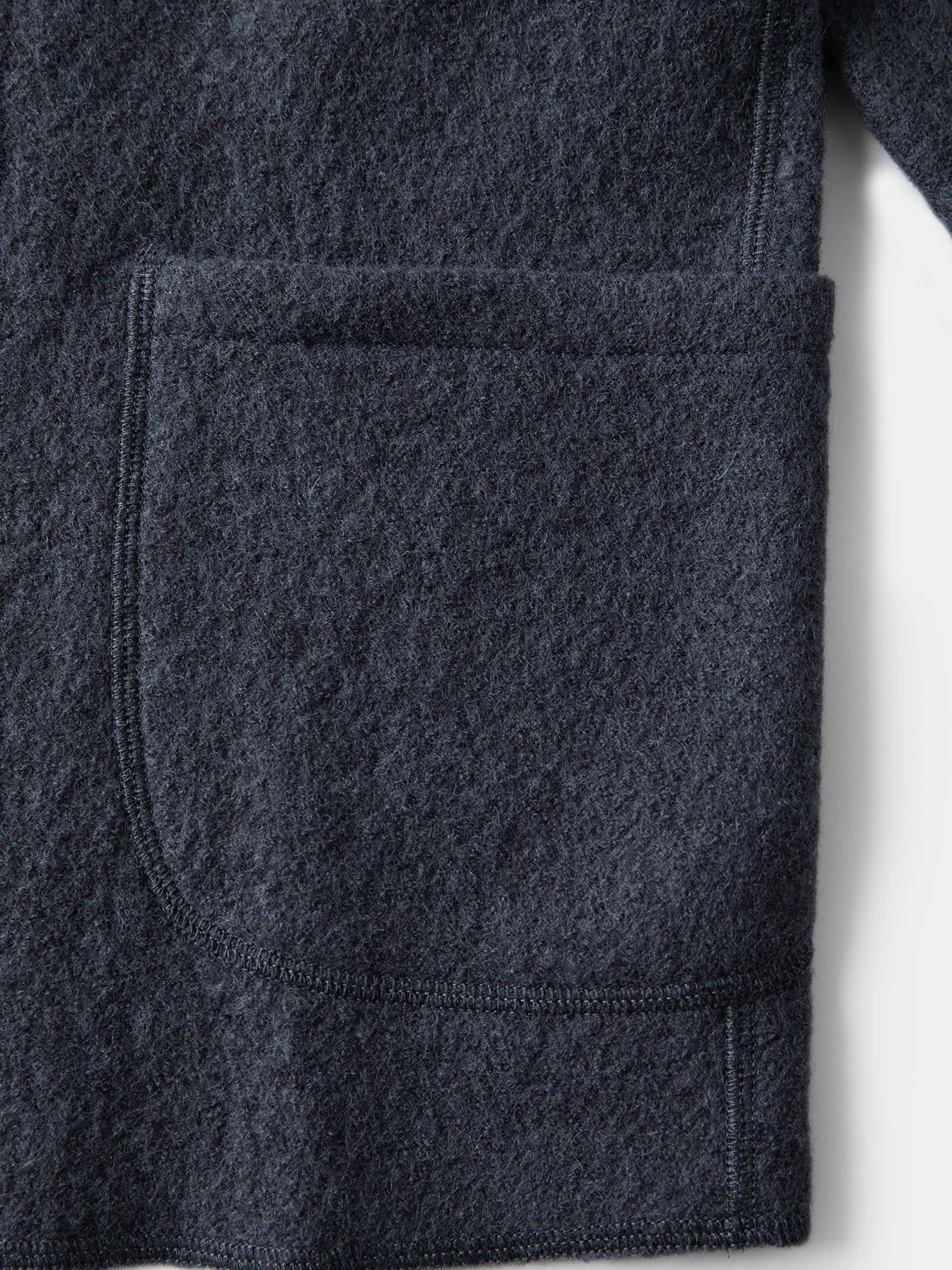 Gray wool felted chore coat side pocket and reinforced hem edge