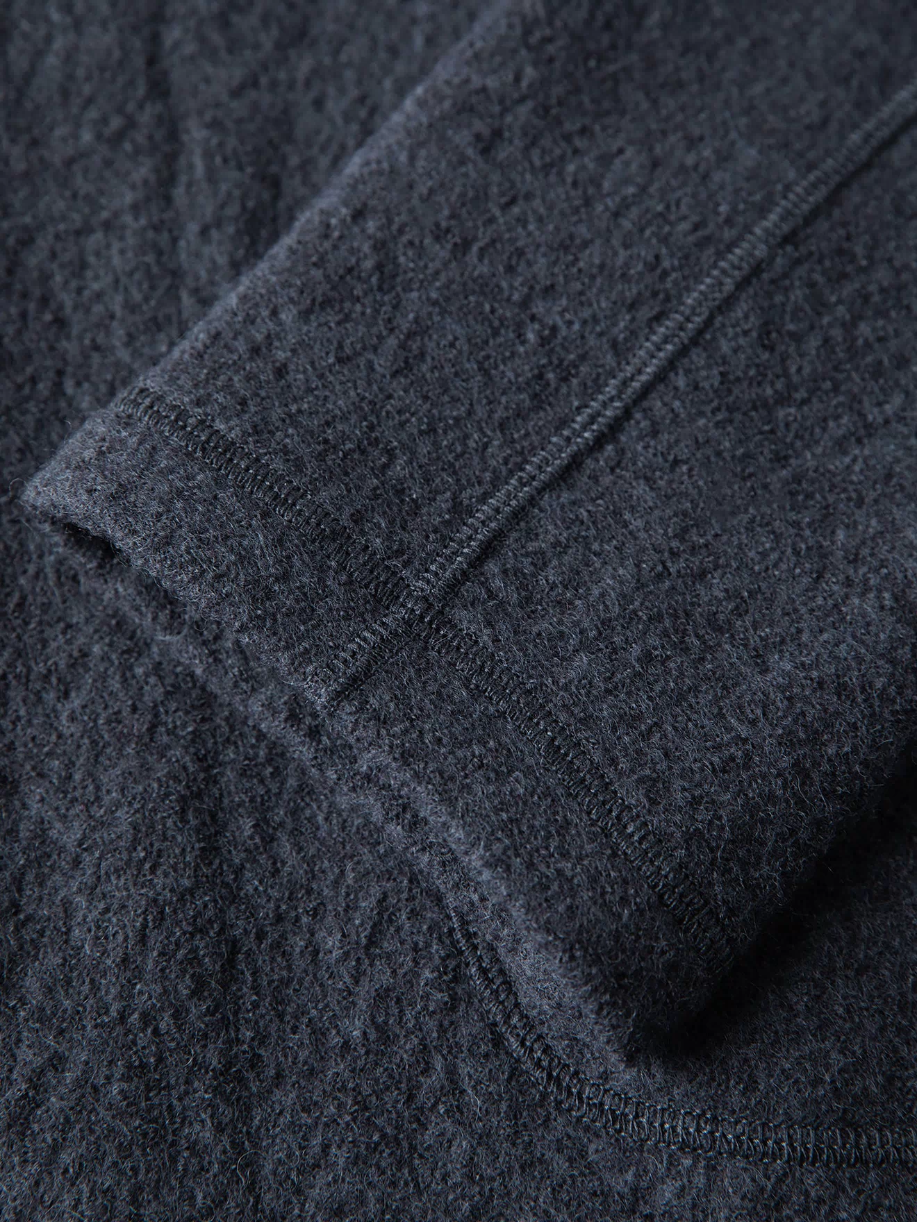 Gray wool felted chore coat sleeve seam and cuff stitching detail