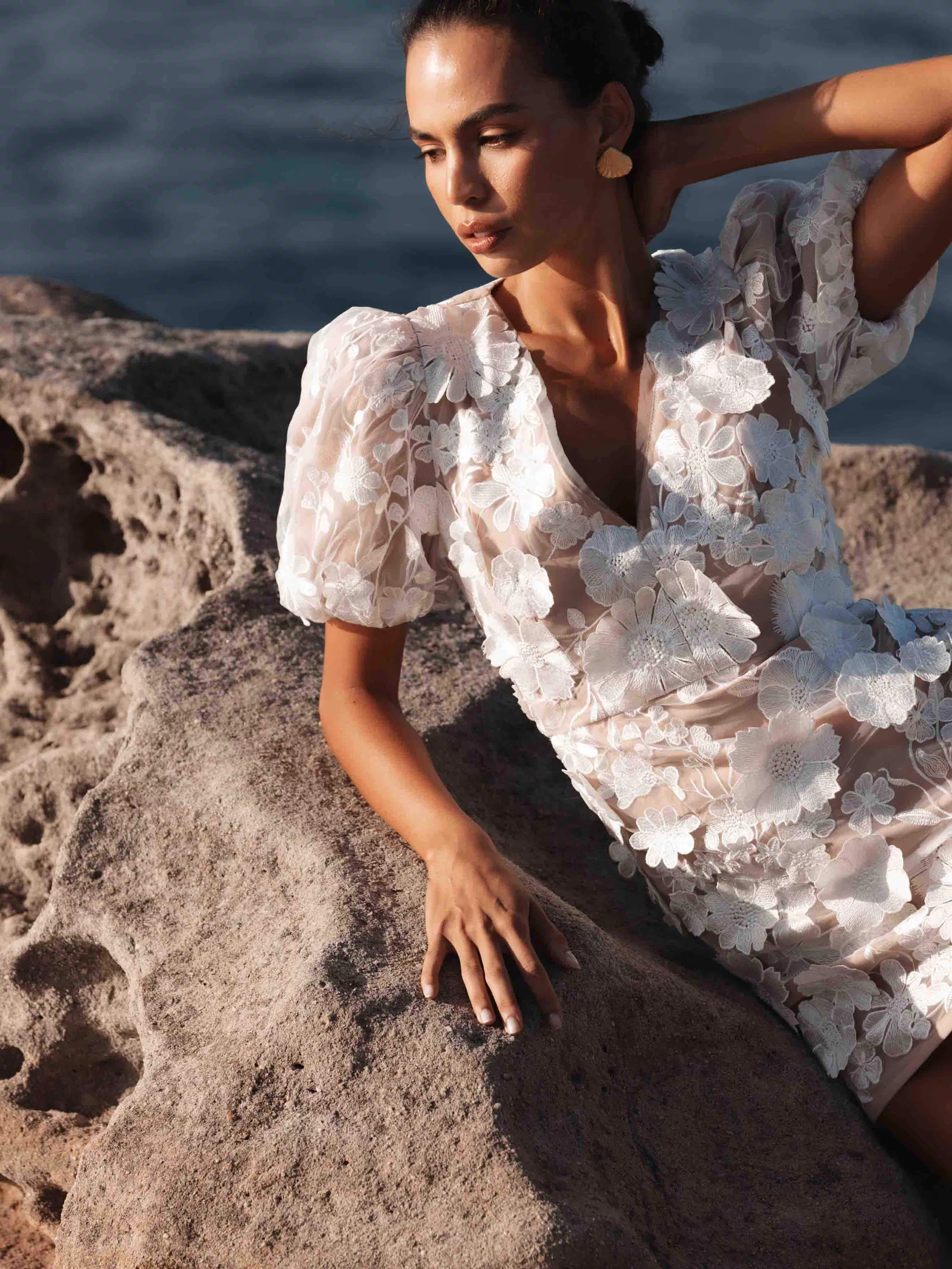 Brunette model wearing Zayla 3D Floral Mini Dress close up campaign shot